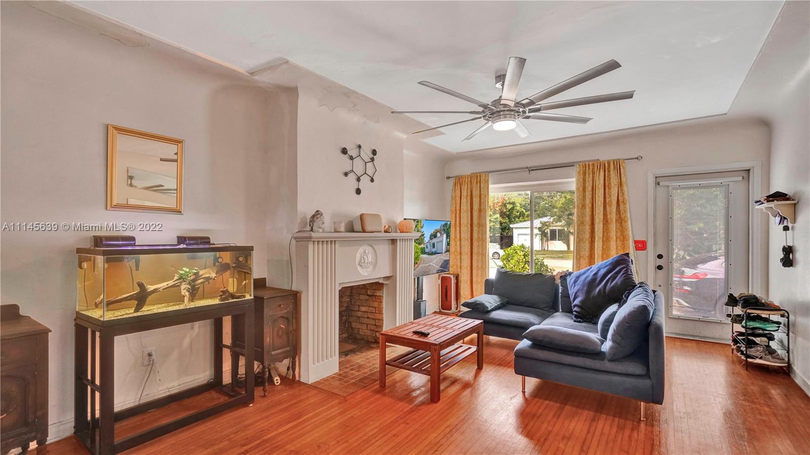 152 Northwest 103rd Street Miami Shores, FL 33150 - Photo 8 of 27 a living room with furniture and a fireplace