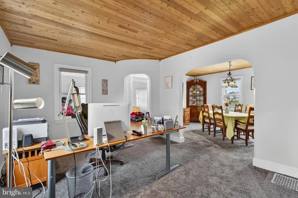 a view of backyard of house with outdoor seating and green space