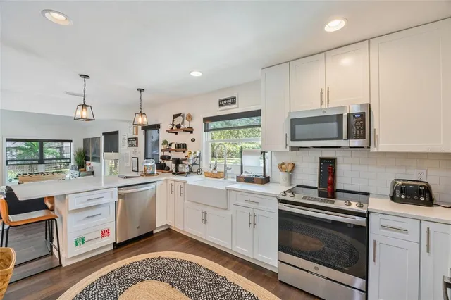 a kitchen with a sink stove and microwave