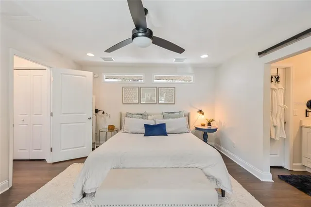 a bedroom with a large bed and a chandelier
