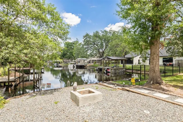 a view of a house with backyard sitting area and garden