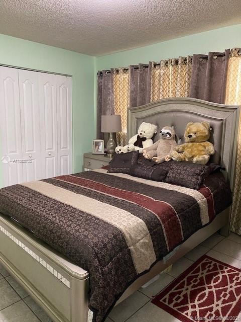 15619 Southwest 73rd Cir Terrace, Unit 106 Miami, FL 33193 - Photo 14 of 18 a bedroom with bed and window