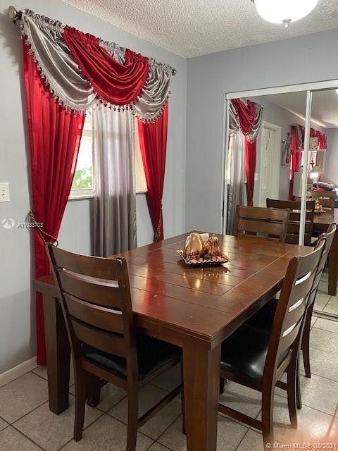 15619 Southwest 73rd Cir Terrace, Unit 106 Miami, FL 33193 - Photo 7 of 18 a view of a dining room with furniture and window