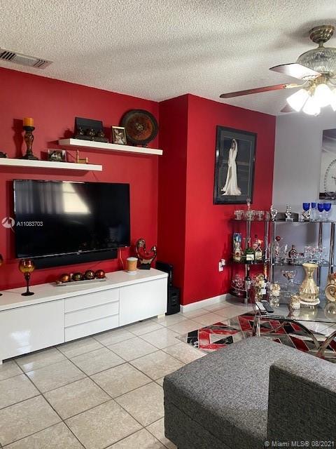 15619 Southwest 73rd Cir Terrace, Unit 106 Miami, FL 33193 - Photo 9 of 18 a living room with furniture and a flat screen tv