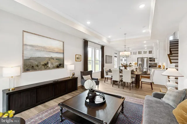 a living room with furniture and a painting on the wall