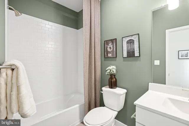 a white toilet sitting next to a bathroom sink