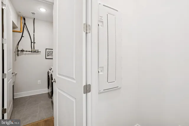 a view of a hallway with wooden floor and entryway