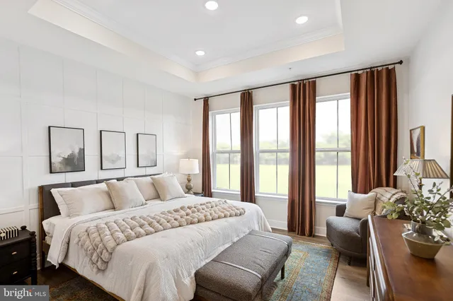 a bedroom with a large bed and a large window