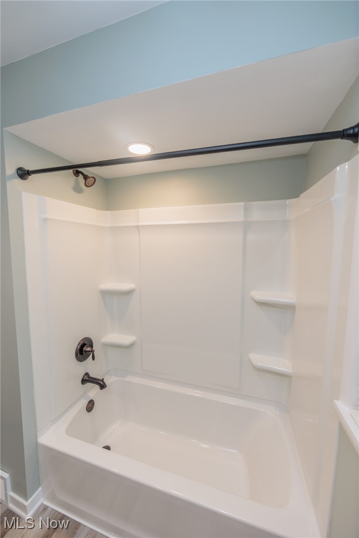 952 Murray Road South Euclid, OH 44121 - Photo 13 of 30 Bathroom featuring shower / bathing tub combination and hardwood / wood-style floors