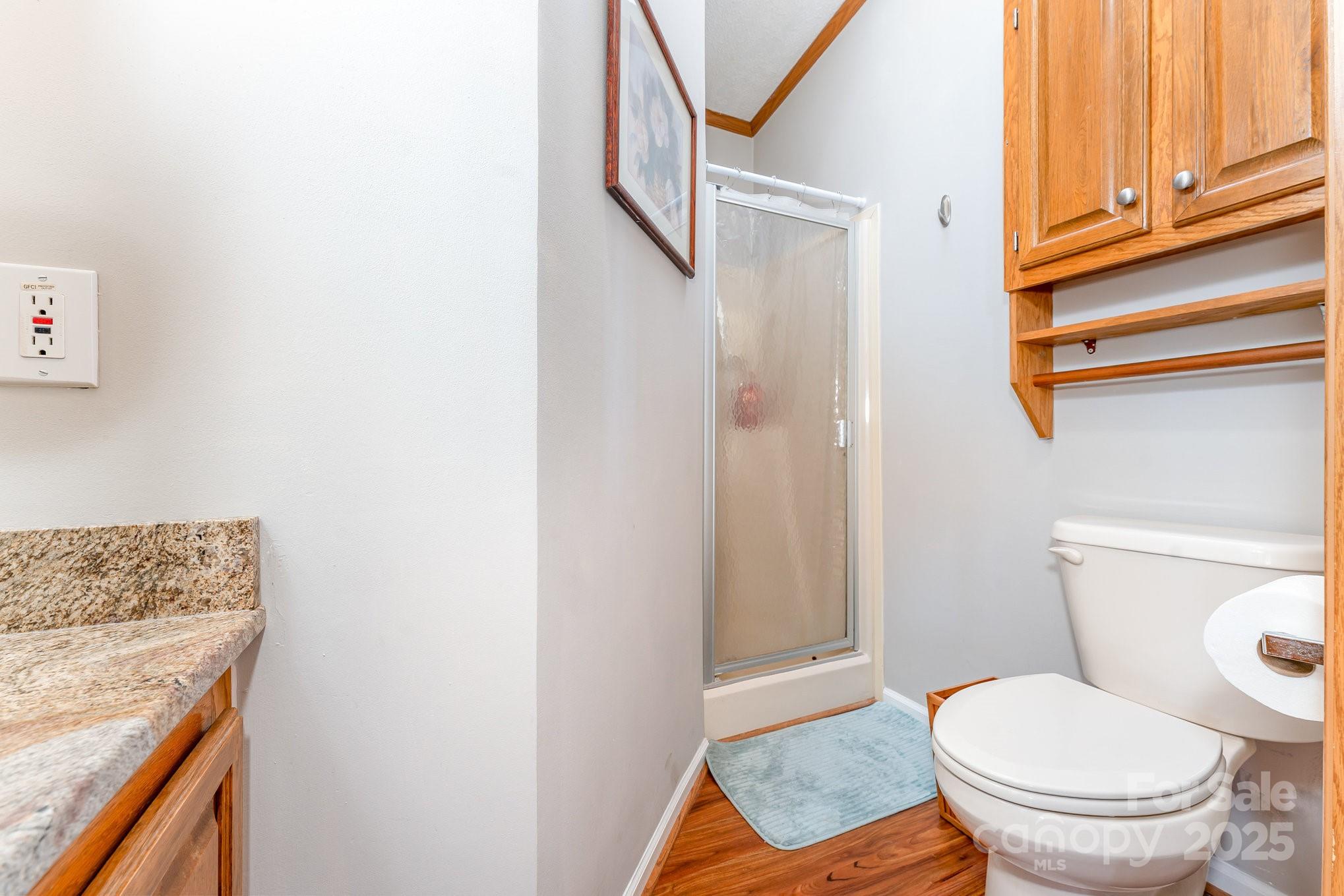 231 Badin Vw Road New London, NC 28127 - Photo 15 of 48 a bathroom with a granite countertop toilet and a sink