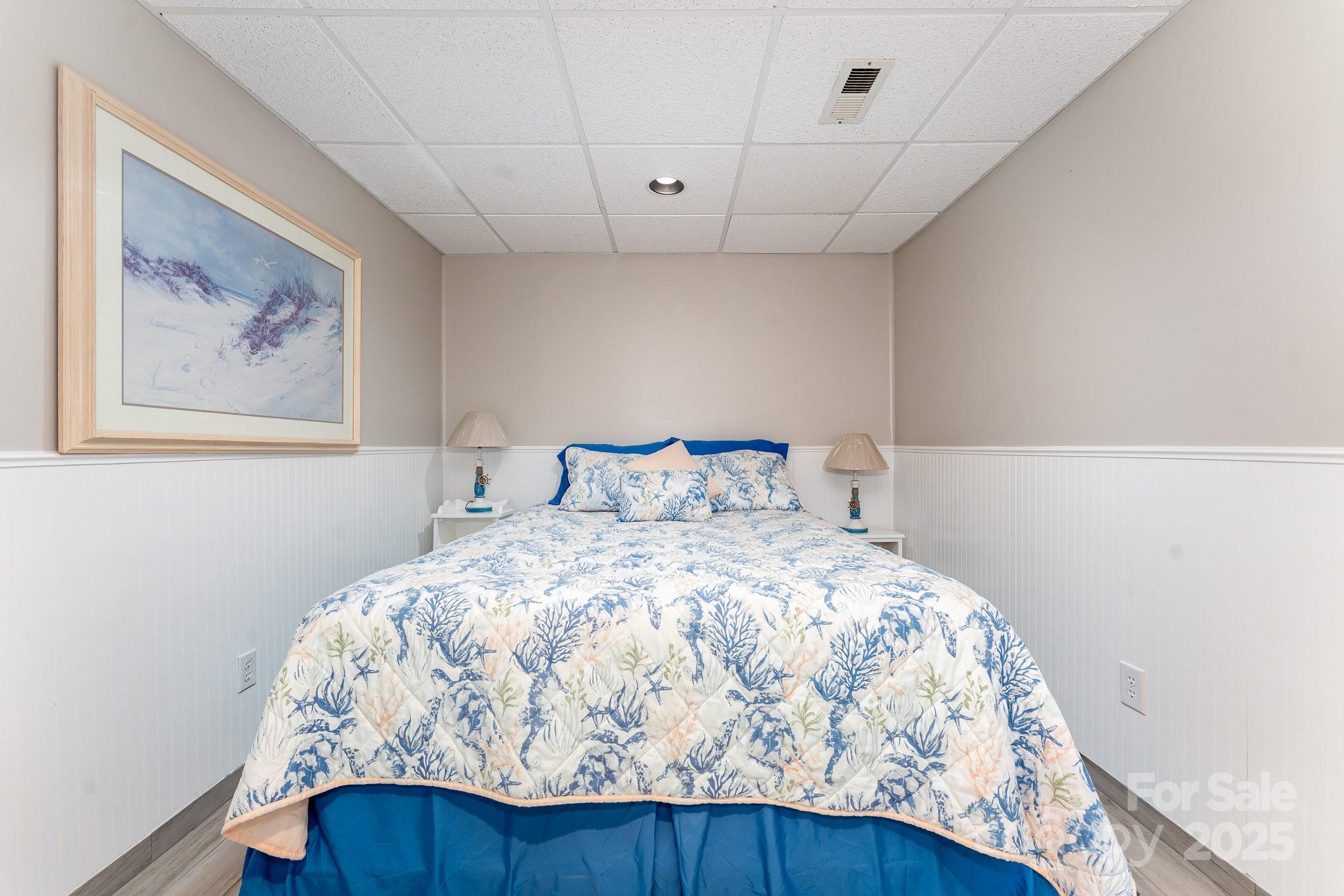 231 Badin Vw Road New London, NC 28127 - Photo 18 of 48 a bedroom with a bed and a painting on the wall