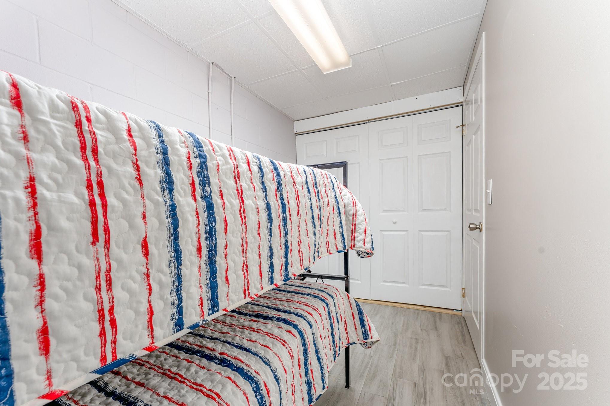 231 Badin Vw Road New London, NC 28127 - Photo 20 of 48 a view of a bedroom with stairs and wooden floor