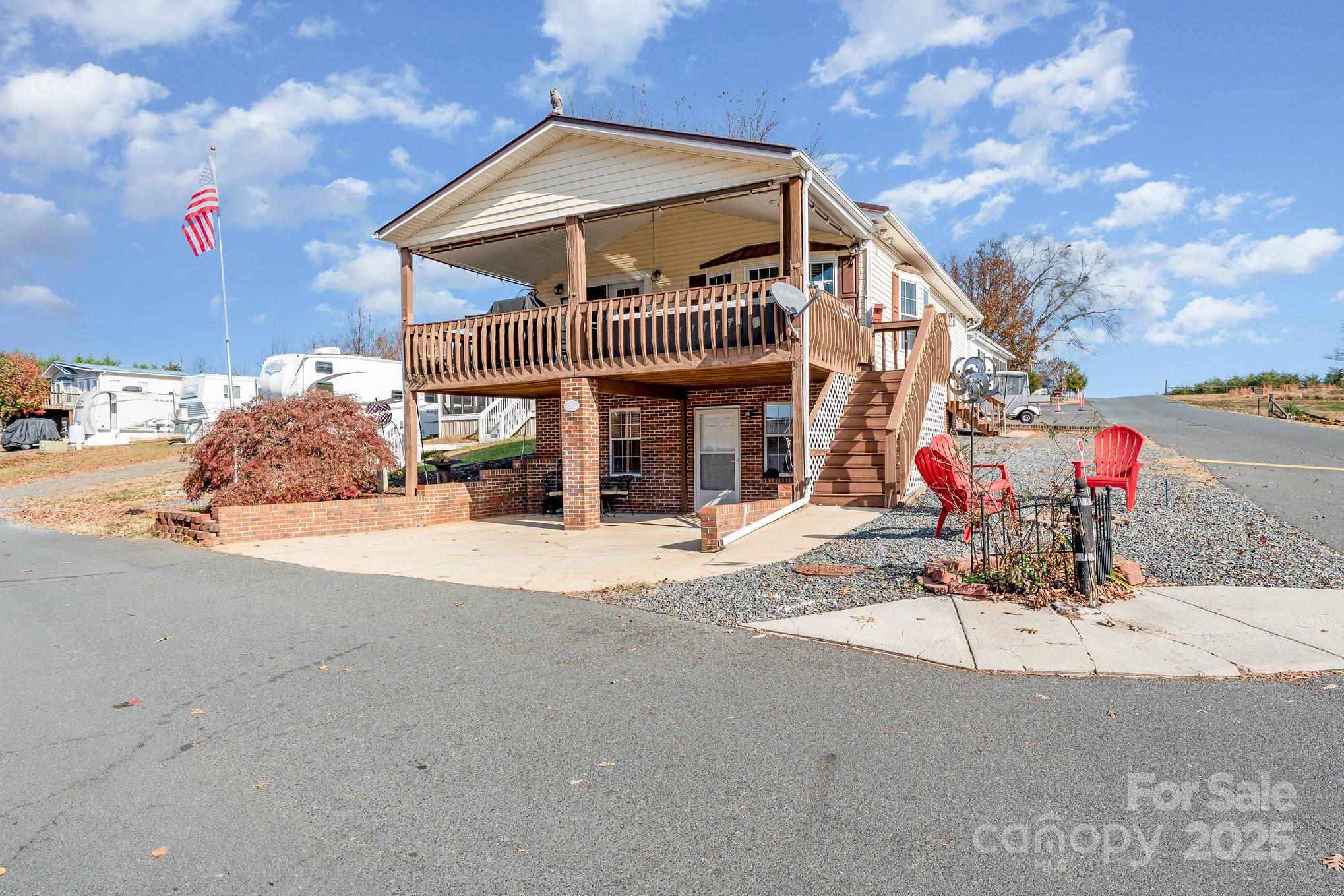 231 Badin Vw Road New London, NC 28127 - Photo 26 of 48 a front view of a house with basket ball court and a fire pit