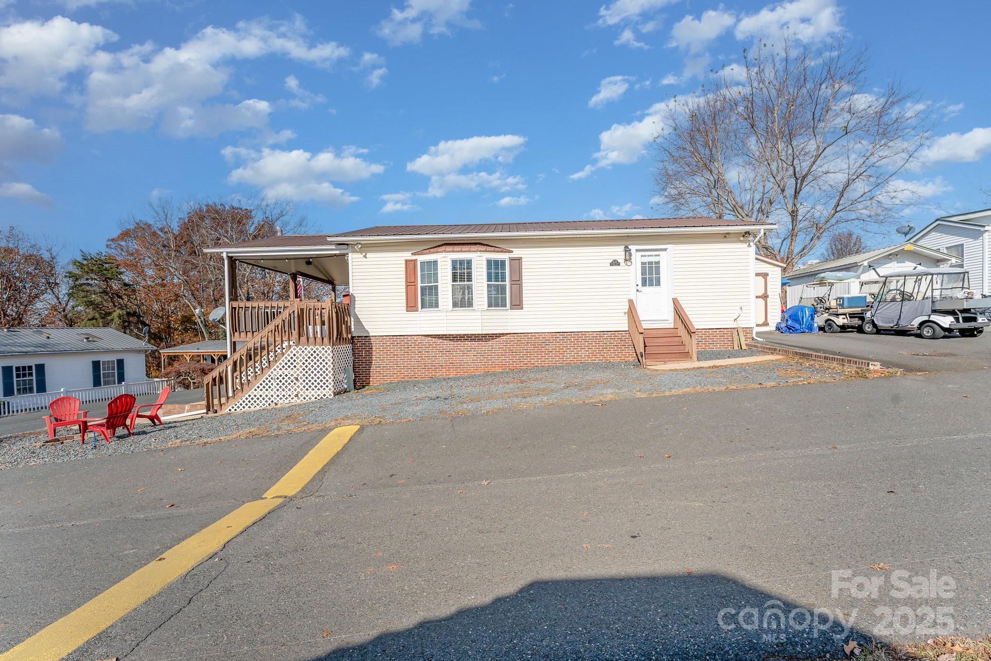 231 Badin Vw Road New London, NC 28127 - Photo 28 of 48 a front view of a house with a yard and garage