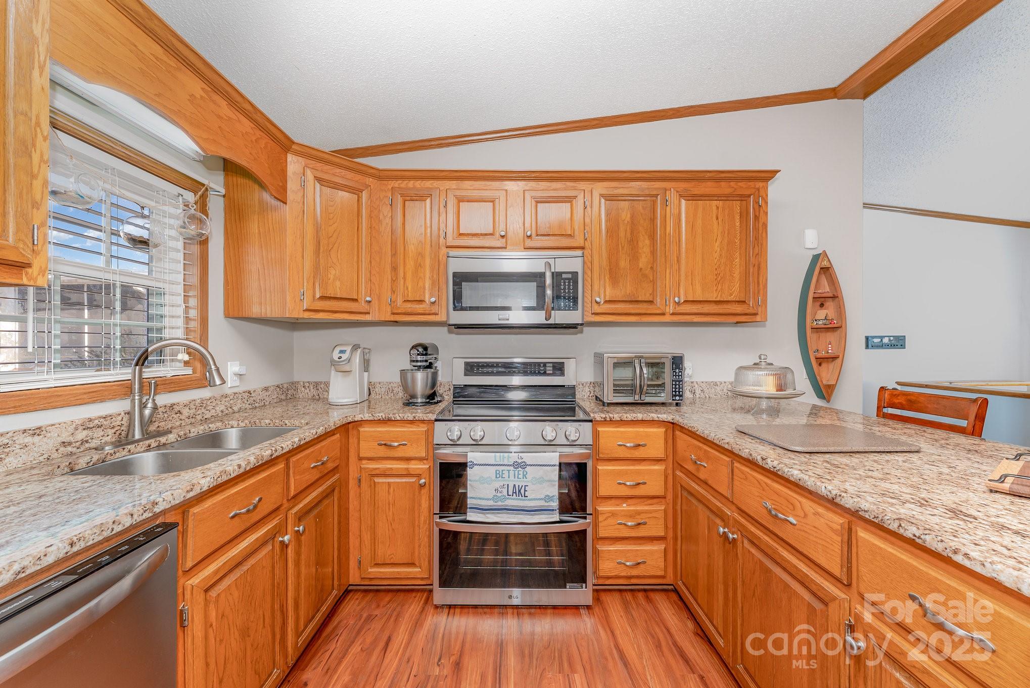 231 Badin Vw Road New London, NC 28127 - Photo 7 of 48 a kitchen with stainless steel appliances granite countertop wooden floor sink stove and granite counter top
