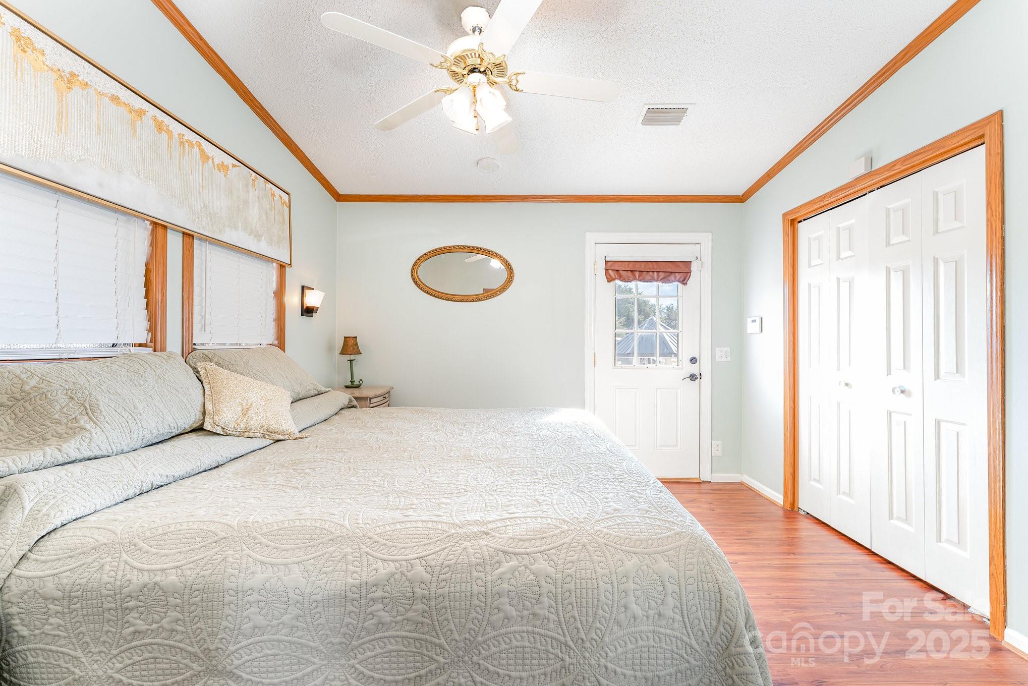 231 Badin Vw Road New London, NC 28127 - Photo 8 of 48 a bedroom with a large bed and a chandelier