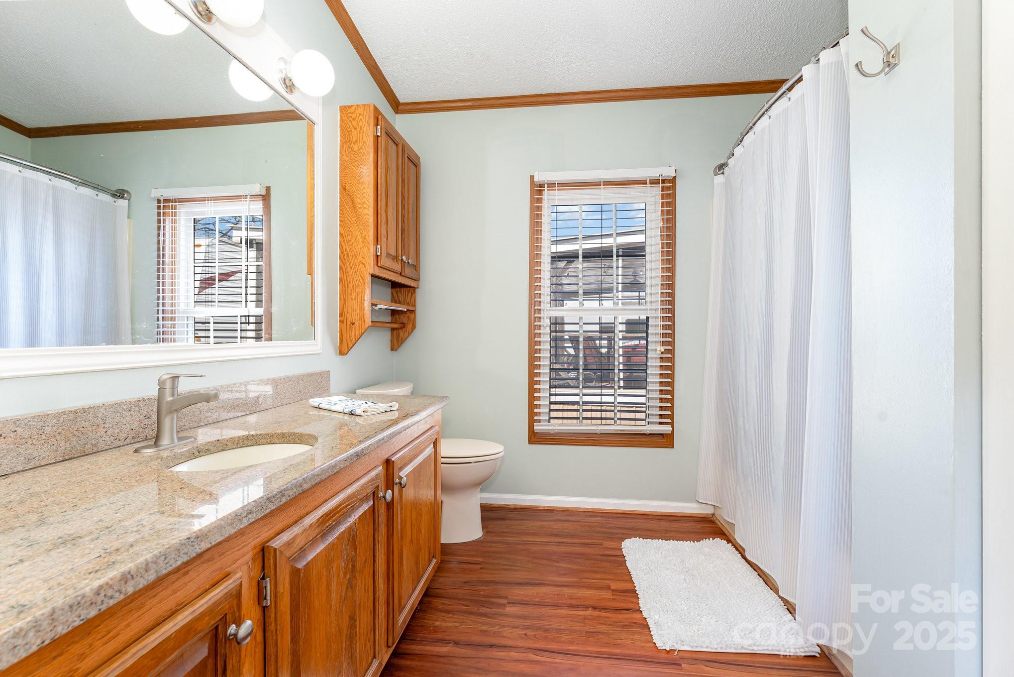 231 Badin Vw Road New London, NC 28127 - Photo 10 of 48 a bathroom with a granite countertop sink and a bathtub