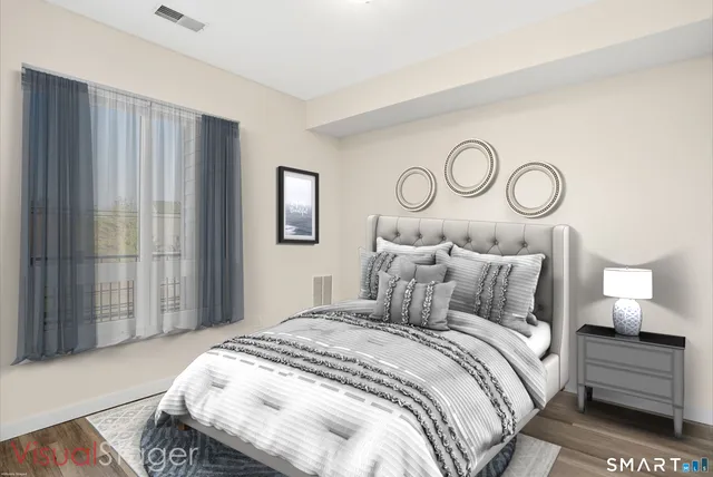 a bedroom with a bed and a lamp