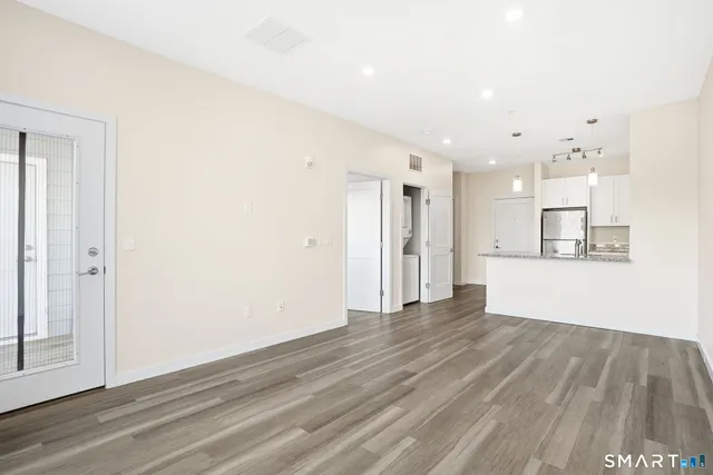 a view of kitchen with refrigerator and window