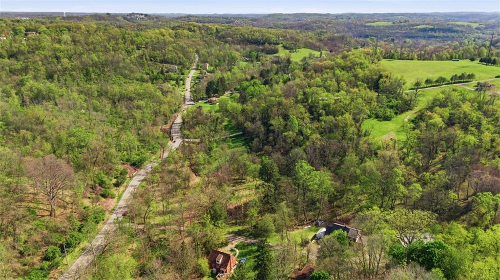 0 Hulton Road Verona, PA 15147 - Photo 13 of 17 a view of a lush green forest with trees and some houses