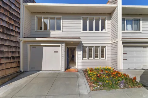 a living room with furniture a fireplace and a floor to ceiling window