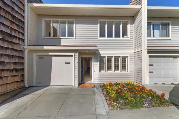 a living room with furniture a fireplace and a floor to ceiling window