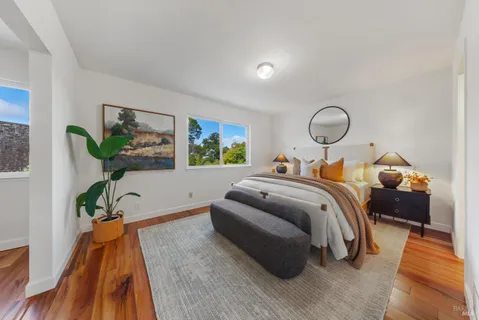 a dining room with furniture potted plants and wooden floor