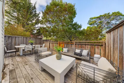 a view of a dinning table and chairs in patio of the house