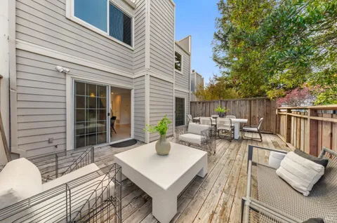a room with wooden floor pool table and windows