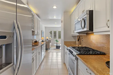 a kitchen with stainless steel appliances granite countertop a stove and a sink