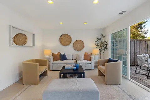 a living room with furniture a large window and a fireplace