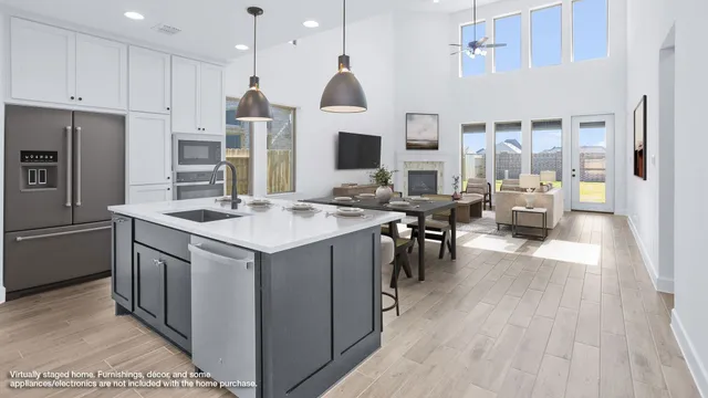 a kitchen with stainless steel appliances granite countertop a sink a stove and a refrigerator