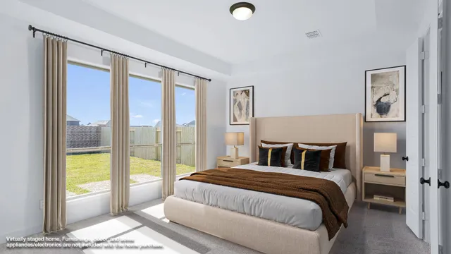 a bedroom with a large bed and a large window