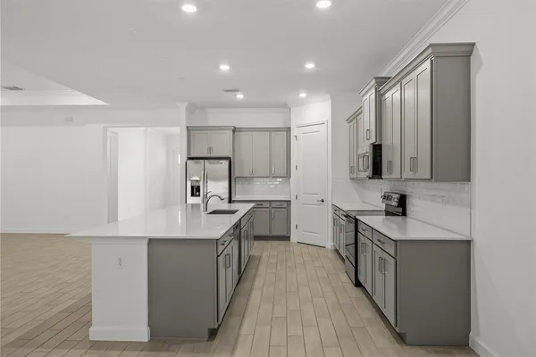 a kitchen with kitchen island white cabinets appliances and sink