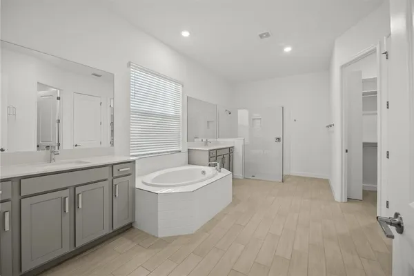 a spacious bathroom with a double vanity sink mirror and double
