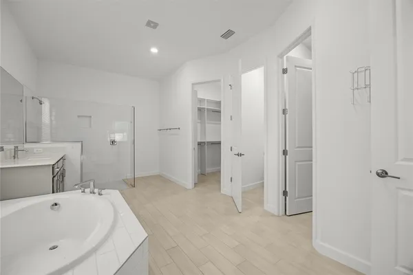 a bathroom with a bathtub and a shower