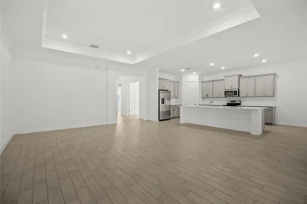 a view of kitchen with wooden floor and large window