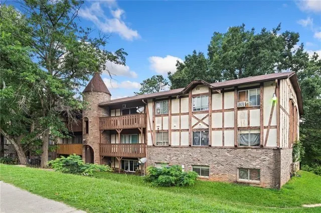 a front view of a house with a garden and plants