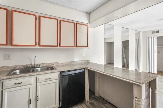 a kitchen with stainless steel appliances granite countertop a sink and a granite counter tops