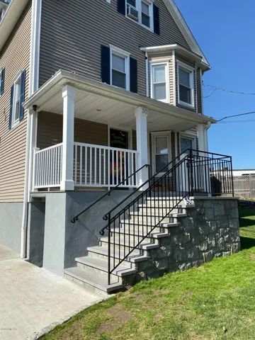 a view of a house with backyard and deck