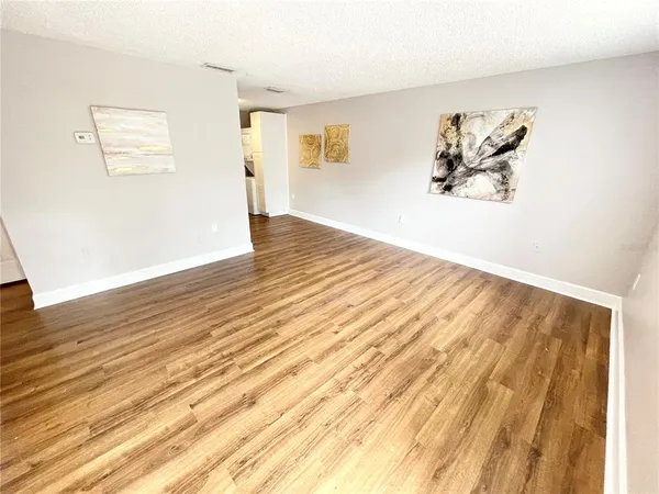 a view of a livingroom with wooden floor and a window