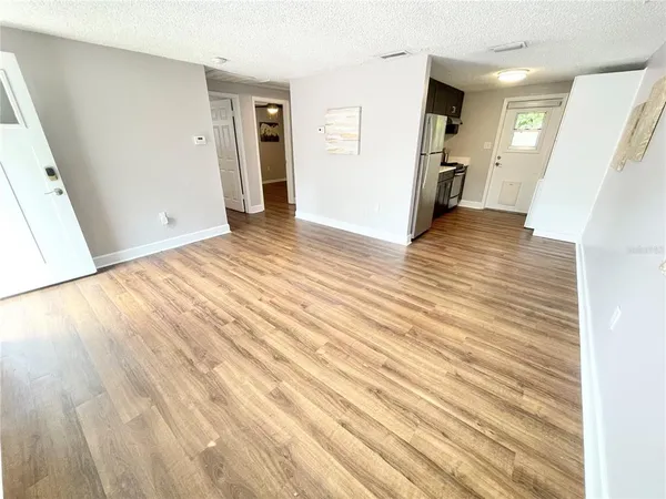 a view of a room with wooden floor and stairs