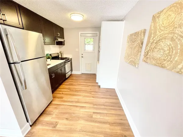 a kitchen with a refrigerator a stove top oven and a refrigerator