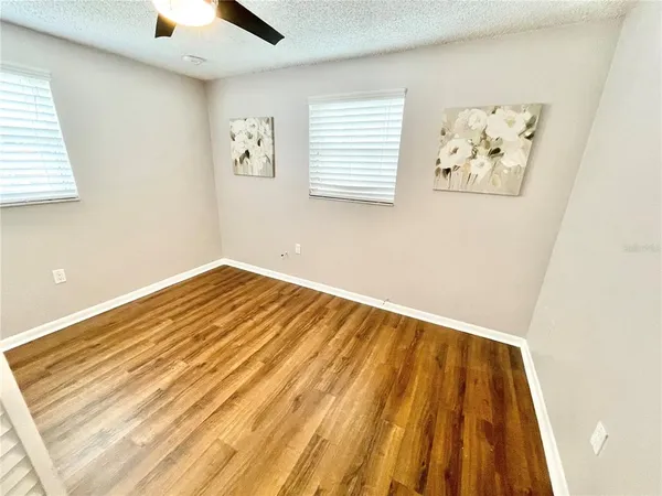a view of a room with wooden floor and a window