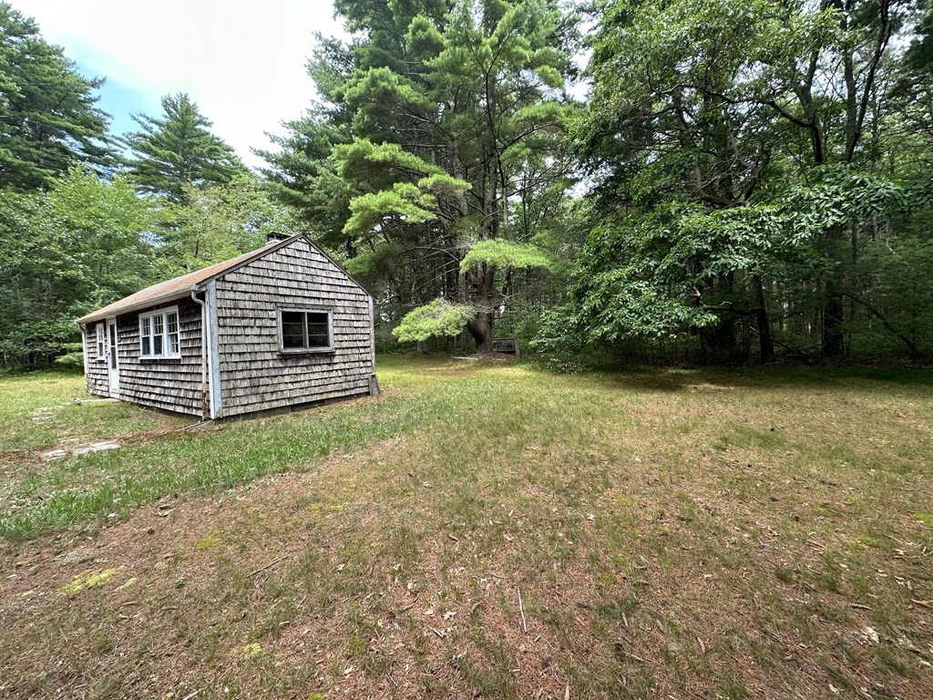5 Fire Island Road Wareham, MA 02571 - Photo 6 of 7 a view of a backyard with a garden