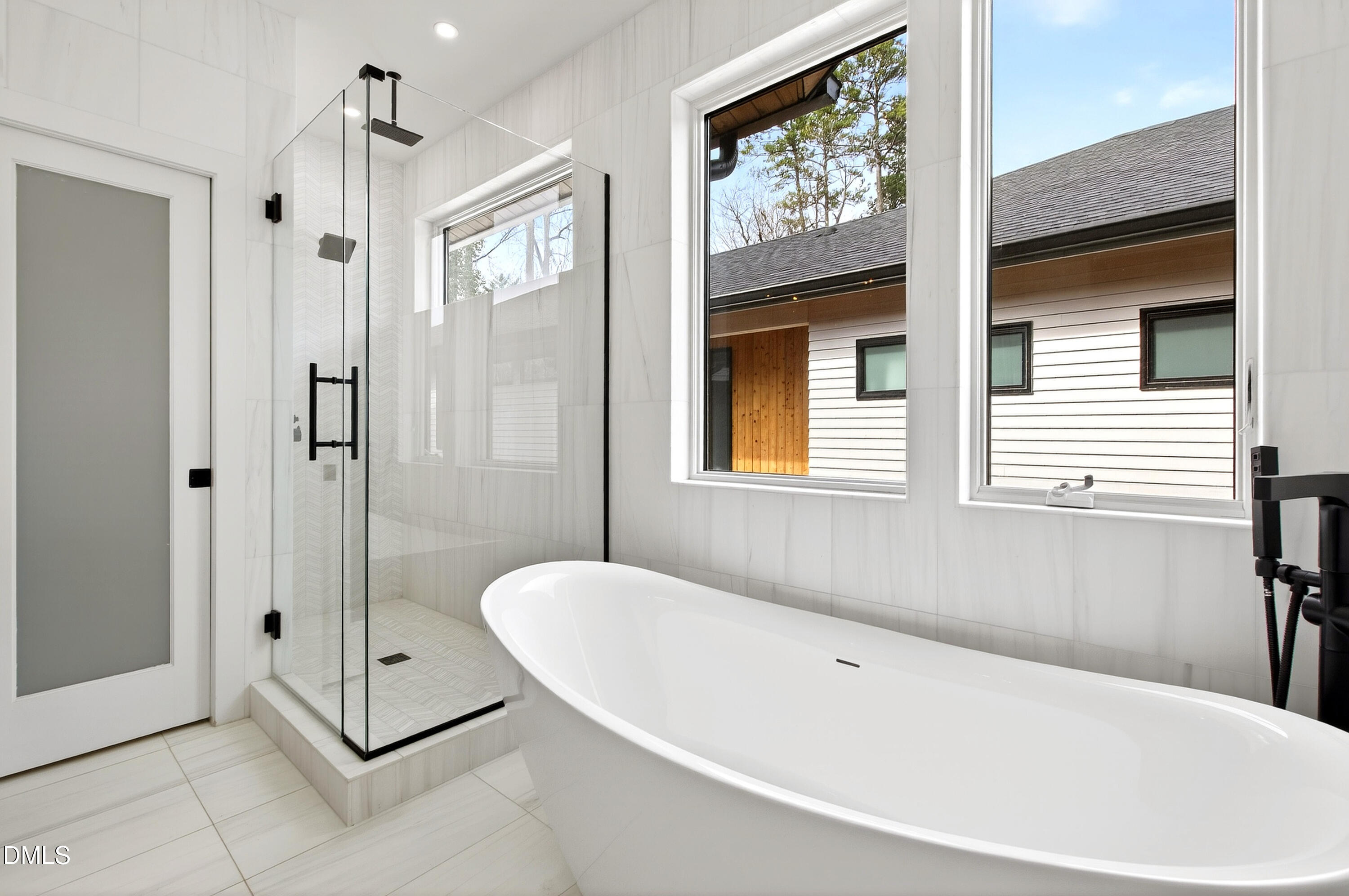 1617 Nottingham Road Raleigh, NC 27607 - Photo 41 of 76 a bathroom with a tub a sink and glass door