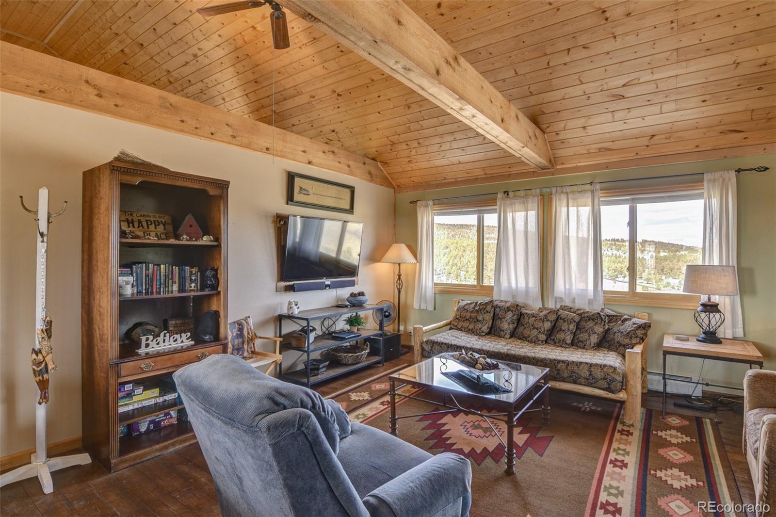 3750 Singletree Road Hartsel, CO 80449 - Photo 17 of 46 a living room with furniture a rug and a large window