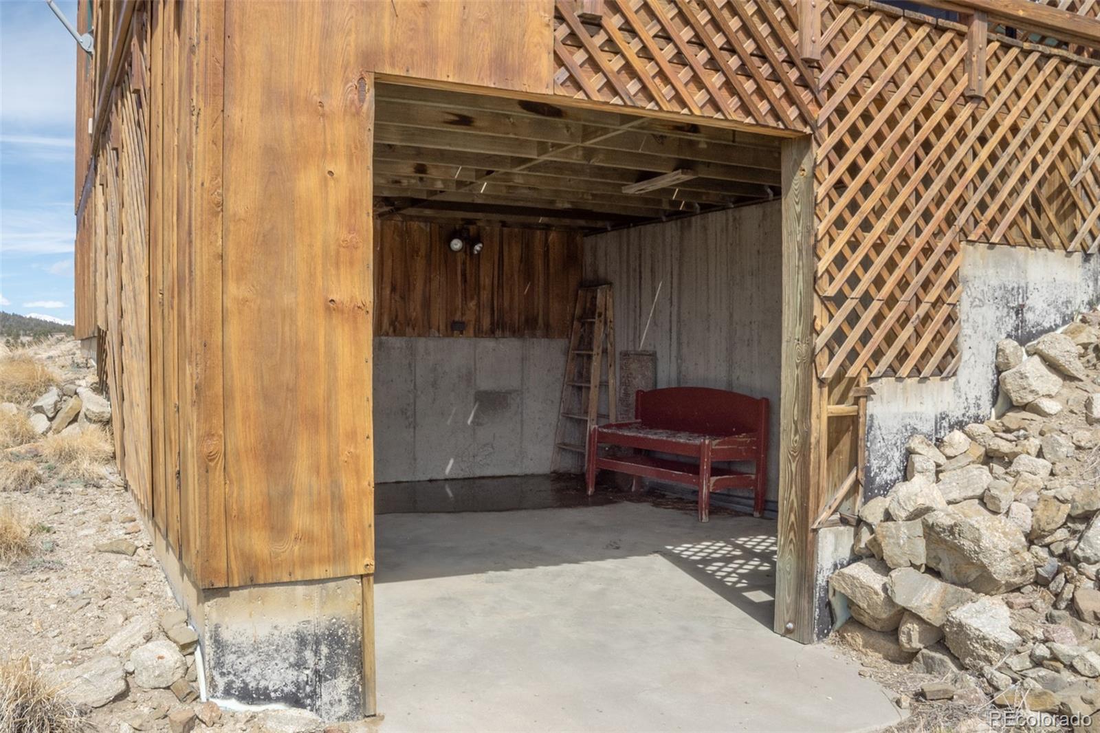 3750 Singletree Road Hartsel, CO 80449 - Photo 43 of 46 a view of a wooden door and chair in the patio
