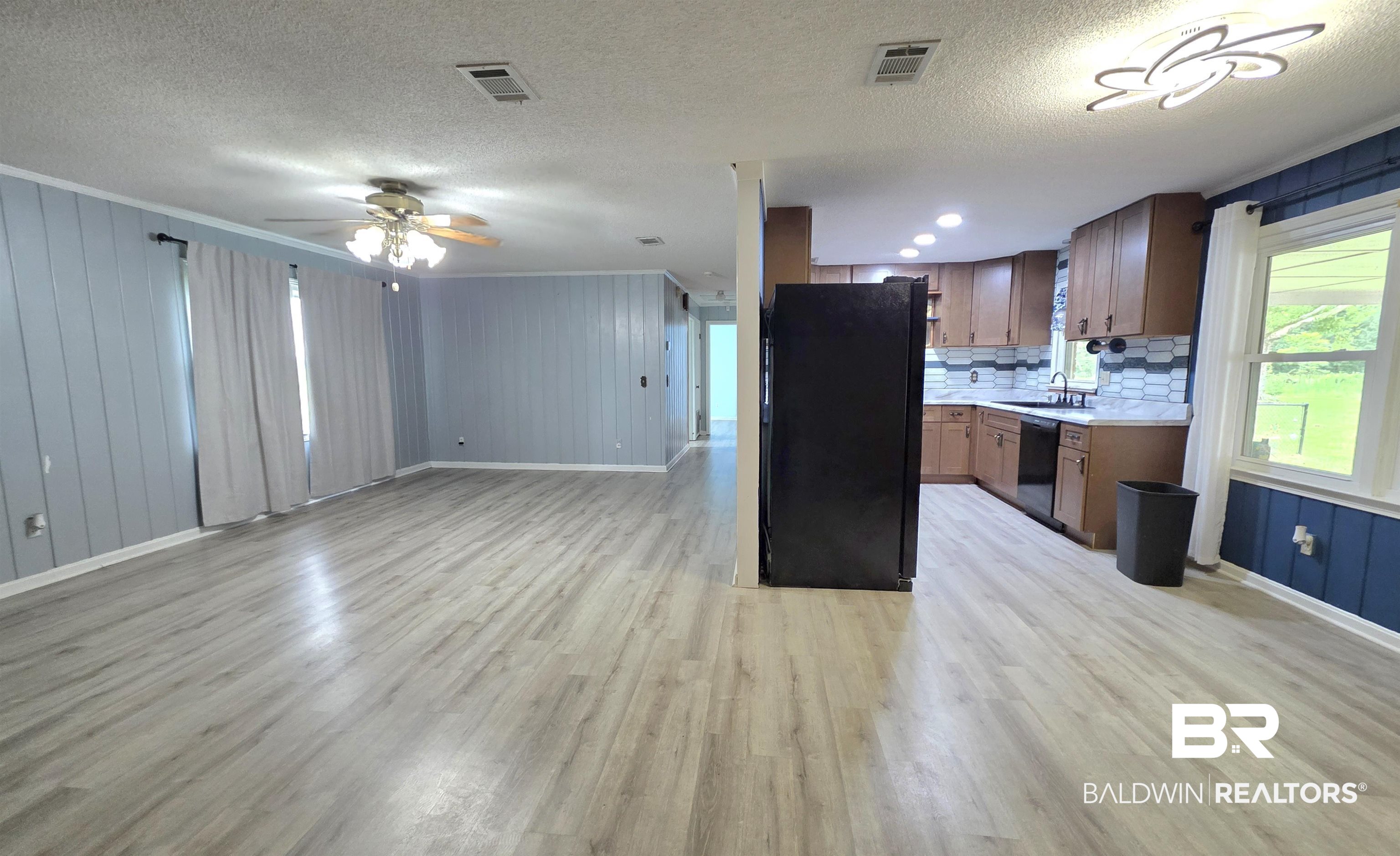 558 Stanton Road Atmore, AL 36502 - Photo 3 of 29 Open-concept living space with wood-finish flooring, a contemporary ceiling fan, and recessed lighting