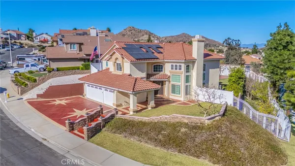 an aerial view of multiple houses with a yard